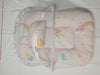 Baby crib with colorful bedding featuring cartoon characters on a white background